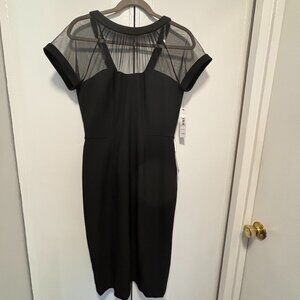 Maggy London tea length black dress. Poly and spandex for stretch fit. Sheer top